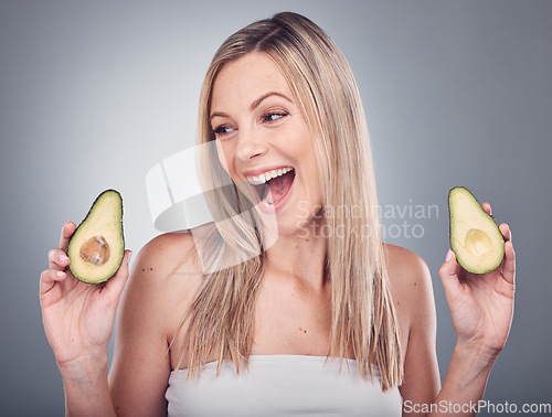 Image of Beauty, avocado and skin or hair care of a woman in studio with natural cosmetics and shampoo for shine. Face of aesthetic model excited on a grey background for hairdresser or sustainable product