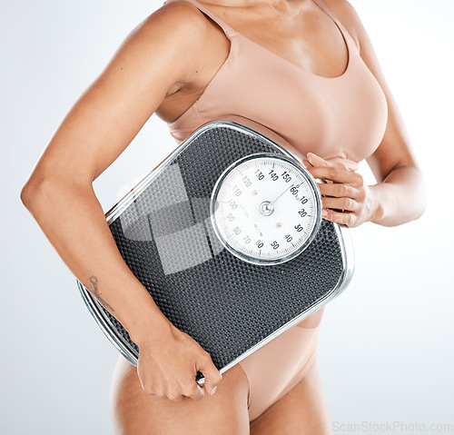 Image of Lose weight, woman or scale for body measurement, diet or healthcare wellness management on isolated studio background. Model, lingerie or underwear for nutrition, workout progress or fitness results