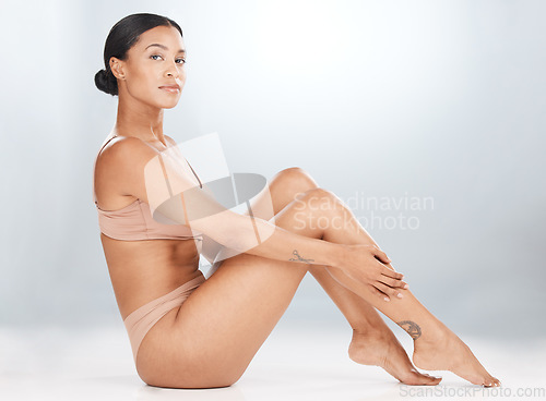 Image of Skincare, black woman and portrait on studio floor for dermatology, wellness and grey background. Beauty, young female and model with shine, natural glow and body hair removal for aesthetic cosmetics