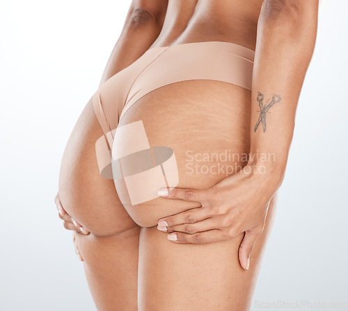 Image of Model underwear, hands or lifting butt in bum surgery, cellulite goal or stretch mark solution for body liposuction. Zoom, lingerie or woman panties on isolated studio background in weight loss check