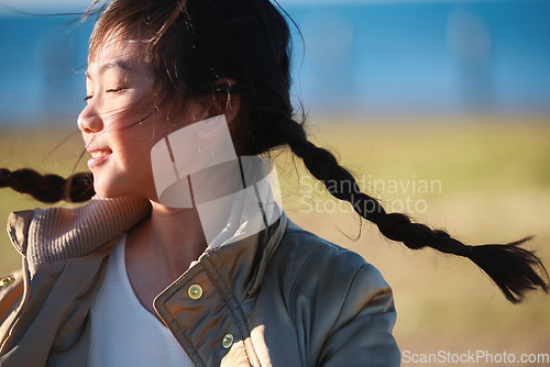 Image of Playful, happy and Asian girl in nature for freedom, running and summer on a field in Singapore. Exercise, free and carefree little child in a park on a bokeh background for playing and happiness