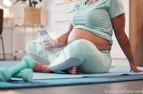 Image of Yoga, pregnant black woman and hands with phone for social media and texting on workout break. Pregnancy, zen pilates and female with mobile smartphone for web browsing or scrolling after training.