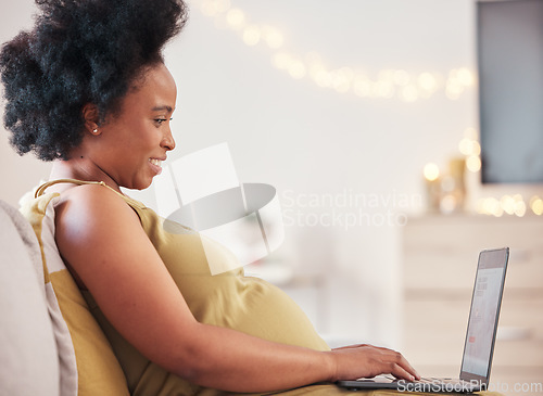 Image of Pregnant, laptop and black woman on sofa typing at home working on a freelance business project. Computer, pregnancy and female remote worker writing report while relaxing on couch in living room.