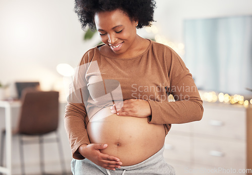 Image of Pregnant, stomach and smile of black woman in home for maternity leave, health and wellness. Pregnancy, prenatal motherhood and female, mama or future mother touching belly with care for healthy baby