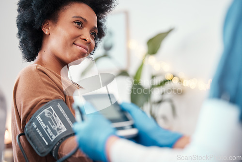 Image of Black woman, healthcare and blood pressure machine in checkup with caregiver for monitoring pulse at home. Happy African American female patient or visit from medical nurse for health and wellness