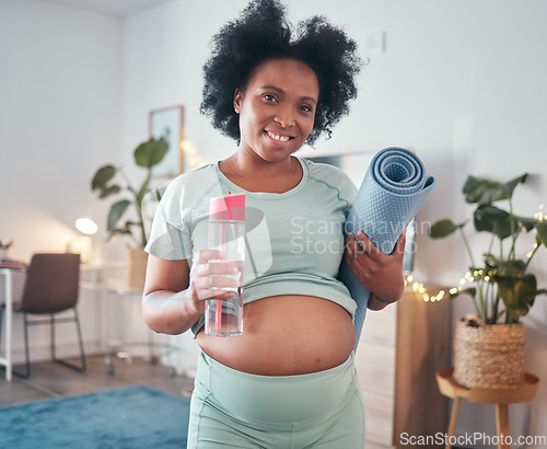 Image of Pregnant, yoga and portrait of black woman in home ready to start exercise, training or workout for health or fitness. Pregnancy, zen pilates and future mother with mat and water bottle for hydration