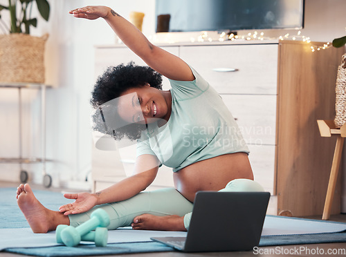 Image of Laptop, pregnant black woman and yoga stretching in home for fitness, wellness and health. Zen, pregnancy and future mom or mother with computer for virtual training or streaming online pilates class