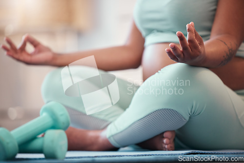 Image of Pregnant black woman, lotus hands and yoga meditation in home for mindfulness, wellness and health. Zen chakra, pregnancy and future mom or mother meditating, training or practicing pilates in house.