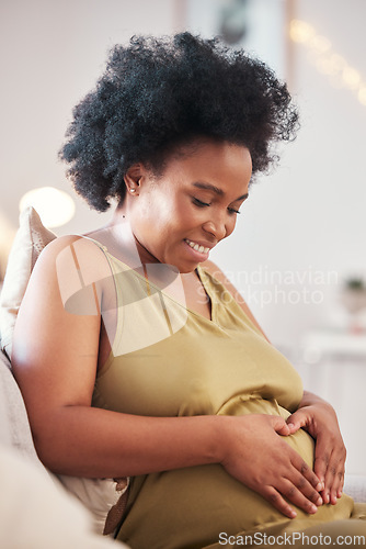 Image of Pregnant, heart hands and black woman stomach with hand sign feeling mother love. Mom care, sofa and living room lounge with person holding abdomen happy about pregnancy and baby on a house couch