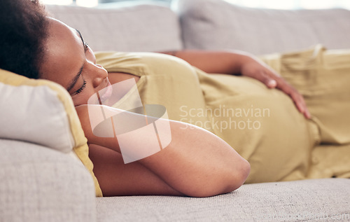 Image of Pregnant, maternity and sleeping woman resting holding her tummy or stomach and relax expecting a baby. Home, pregnancy and lying on a couch or sofa in a house or apartment on a break in a lounge