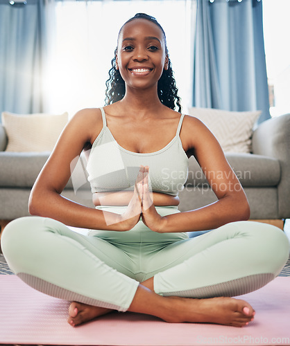 Image of Yoga, namaste woman and zen portrait in living room for fitness, exercise and mindfulness, healing or peace. Meditate, spiritual and black person praying or prayer hands for happy, self care wellness