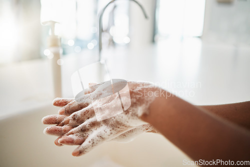 Image of Woman, hands and cleaning with soap, water and tap at home for hygiene. Closeup, hand skincare and bacteria risk in bathroom, house and safety for healthy lifestyle, wellness and self care at sink