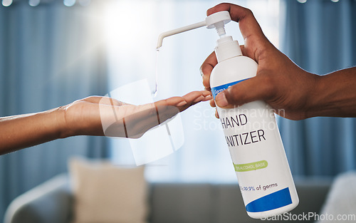 Image of Hands, sanitizer and drop for hygiene, bacteria or germs to combat disease, illness or virus at home. Hand of person using chemical, alcohol or hand wash for safety, protection or disinfect indoors