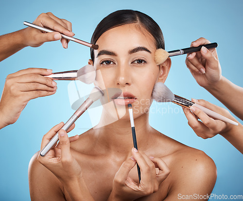 Image of Portrait, woman and brushes for makeup, skincare and dermatology with lady on blue studio background. Face, female and girl with cosmetics tools, natural beauty and foundation for glow and soft skin