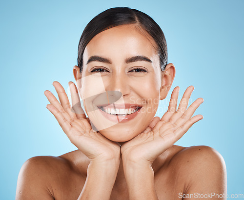 Image of Skincare, facial and portrait of woman with smile on blue background for luxury, wellness and cosmetics. Spa aesthetic, dermatology and face of girl with hands for beauty, treatment and healthy skin