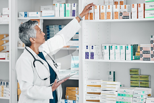 Image of Pharmacy, tablet and medicine with senior woman in store for healthcare, wellness or retail. Product, technology and stock with pharmacist checking drugs outlet for shopping, medical or inventory