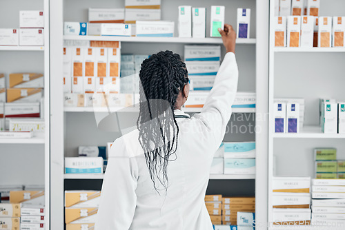 Image of Choice, back and pharmacist at a shelf for medicine, inventory and check on pills in a clinic. Medical, healthcare and black woman working with medication at a phamacy for service, health and work