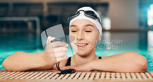 Image of Time, exercise and girl with a watch for swimming, fitness and motivation in a pool. Check, sports and happy athlete reading a timer for workout, cardio and competition in the water for a race