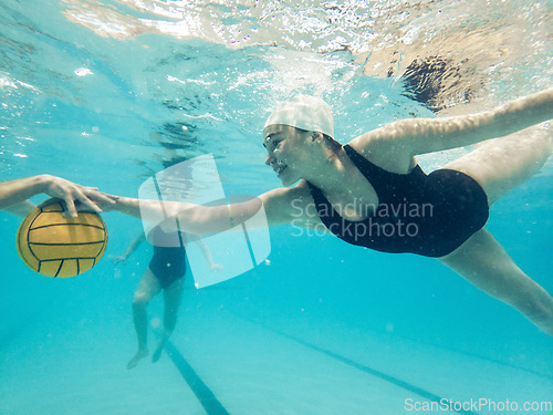 Image of Water polo, catching and women underwater for a ball during a competition, game or swimming. Teamwork, action and blurred athlete team playing a professional match in a pool for a championship