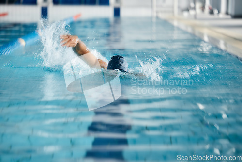 Image of Athlete, speed or freestyle stroke in swimming pool cap for sports wellness, training or exercise for body healthcare. Workout, fitness and swimmer man in fast motion for water competition challenge