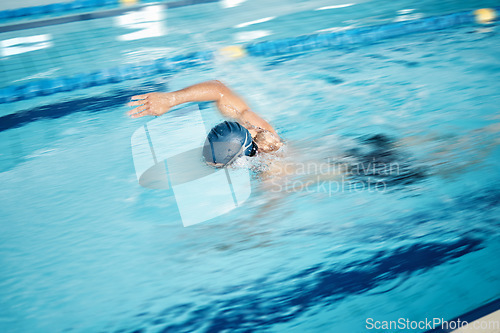 Image of Man, motion blur or freestyle stroke in swimming pool for sports wellness, training or exercise for body healthcare. Workout, fitness or speed swimmer athlete in water competition or cardio challenge