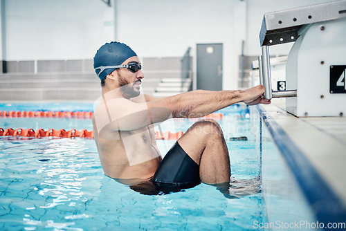 Image of Sports, swimming pool and man start race in water for training, exercise and workout for competition. Fitness, motivation and professional male athlete with hands on starting podium for back stroke