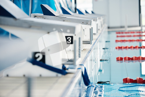 Image of Sports, competition and podium row by swimming pool for training, exercise and workout for water sport. Fitness mockup, motivation and professional starting block for diving, triathlon and race