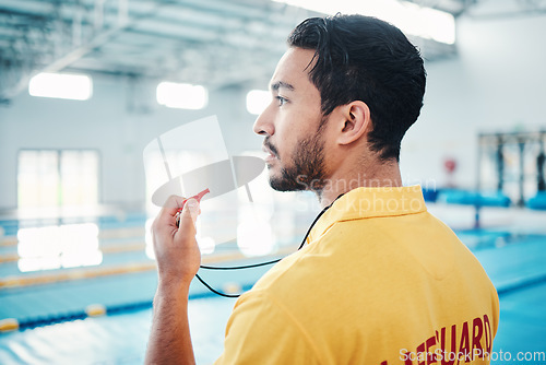 Image of Lifeguard, whistle and swimming pool safety by man watching at indoor facility for training, swim and practice. Pool, attendant and guy water sports worker monitoring exercise, danger and swimmer