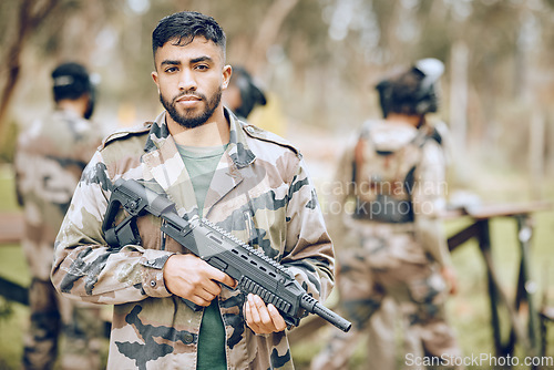 Image of Paintball, portrait or soldier with a gun, mission or motivation on a military battlefield ready tor war. Army, mindset or man with focus, hero mindset or weapon for a fun shooting game on holiday