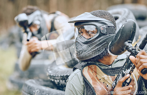 Image of Paintball, warrior or black man thinking in a shooting game of fighting action on a fun battlefield. Mission focused, military or player with a gun or weapons for survival in an outdoor competition