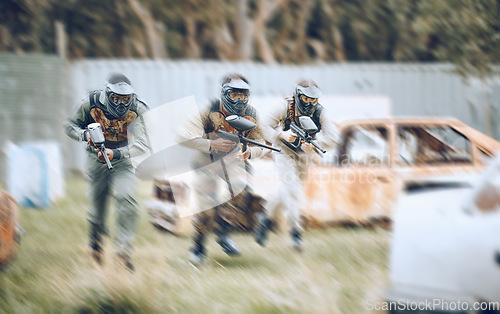 Image of Paintball, team work or men running in a shooting game with speed or fast action on a fun battlefield. Mission focused, military or people running with weapons or guns for survival in a competition