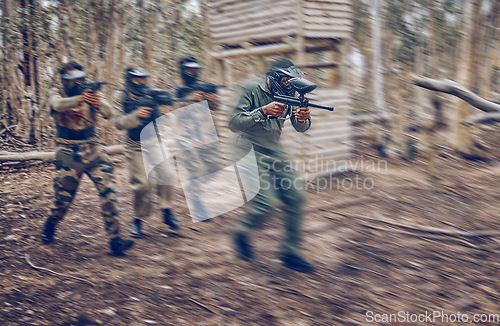 Image of Paintball, team work or men running in a shooting game with speed or fast action on a fun battlefield. Mission focus, military or people with guns for survival in a competition in nature or forest