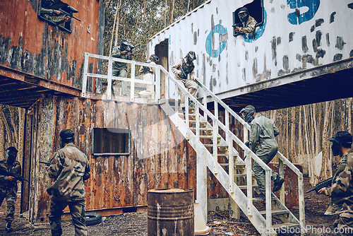 Image of Paintball, steps or men in a container or shooting game playing with speed, fast or fun action. Mission focus, military or people running in battle with guns for survival in an outdoor competition