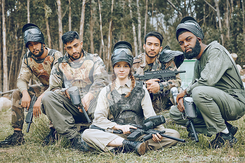 Image of Paintball, portrait or team in a shooting game playing or training on a fun battlefield in nature. War mission, military or people with guns or weapons gear for survival in a competition in a forest