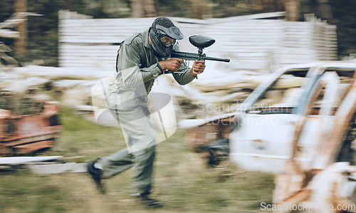 Image of Paintball, speed or man running in a shooting game playing with fast war action on a fun battlefield. Mission focus, military or guy with a gun or weapon gear for survival in an outdoor competition