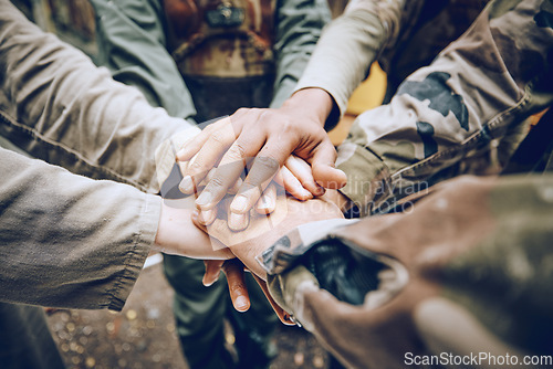 Image of Military, team work or hands in a huddle for a mission, strategy or motivation on a paintball battlefield. Goals, collaboration or army people with support in a partnership or group of ready soldiers