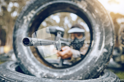 Image of Gun, target or man in a paintball shooting game playing on a military battlefield on holiday vacation. Mission focus, army or sniper aiming with weapons gear for survival in an outdoor competition