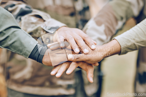 Image of Army, huddle or hands with a mission, strategy or motivation on a paintball or military battlefield in nature. Goals, team work or people with support in a partnership or group of ready soldiers