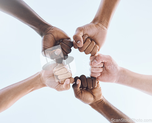 Image of People, team and hands or fist bump of men in support of sport, collaboration and game strategy on sky. Teamwork, players and man group hand huddle for fitness, motivation and bottom of training goal