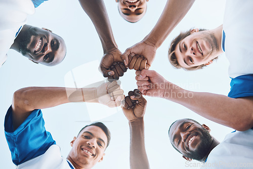 Image of Sports, teamwork and fist bump circle for soccer for support, motivation and community on field. Diversity, team building and low angle portrait of football players ready for game, training and match
