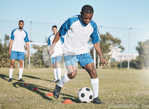 Image of Sports, soccer and black man training with ball for practice, playing game and exercise on outdoor field. Motivation, energy and male football player kick, running and score goals for fitness workout