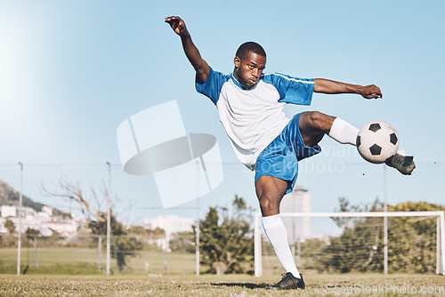 Image of Sports, soccer and black man kick ball playing game, training and exercise on outdoor field. Fitness, workout and male football player in action, running and score goals, winning and competition