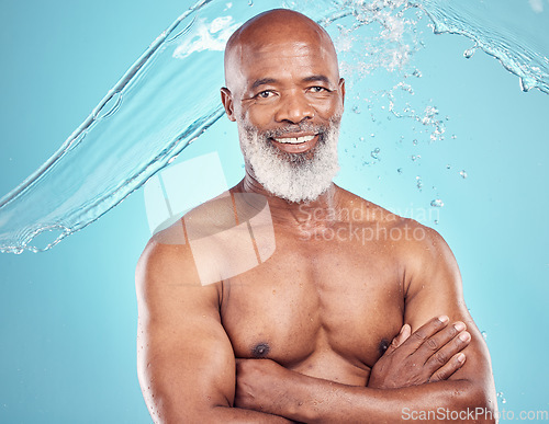 Image of Senior man, skincare and portrait with water splash in studio, grooming and beauty on blue background. Elderly, model and guy relax while cleaning, hygiene and skin wellness, hydration and isolated