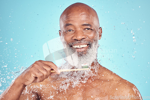 Image of Water splash, toothbrush and portrait of black man with smile on face, mockup isolated on blue background. Teeth, toothpaste and product placement, senior dental care and cleaning mouth in studio