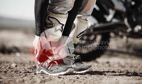 Image of Ankle, injury and motorcycle with the hands of a man holding his joint in pain while outdoor for a race. Sports, training or anatomy with a male athlete suffering an accident on a ride for recreation