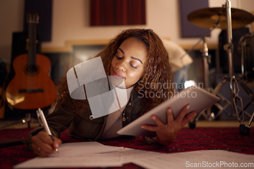 Image of Digital tablet, songwriter and woman writing music, idea and composition in studio, happy and smile. Female, artist and composer online for creative, planning and audio, track and sound production