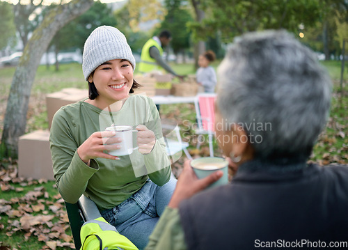 Image of Volunteer, coffee and break by women relax after community service, cleanup and project in park, happy and bond. Charity, environment and recycling friends resting in a forest with tea and a talk