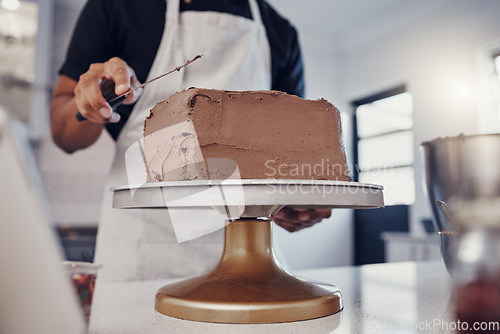 Image of Frosting, baking and man with a cake in the kitchen for birthday food, dessert and pudding. Cooking, preparation and baker learning to decorate a sweet treat for a celebration on a table in a house