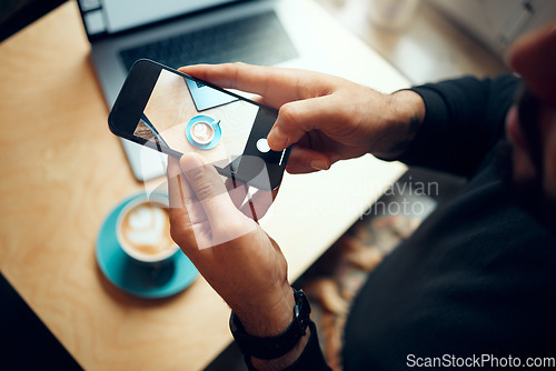 Image of Hands, phone and photo of coffee at cafe for social media, post or photography at an indoor shop. Hand of man taking picture of hot beverage, vlog or cup with mobile smartphone by small table