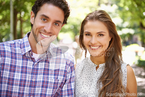 Image of Park, portrait and couple on a outdoor date with happiness and love together in nature. Sunshine, vacation and fun with a smile in summer on holiday feeling relax in the sun with blurred background